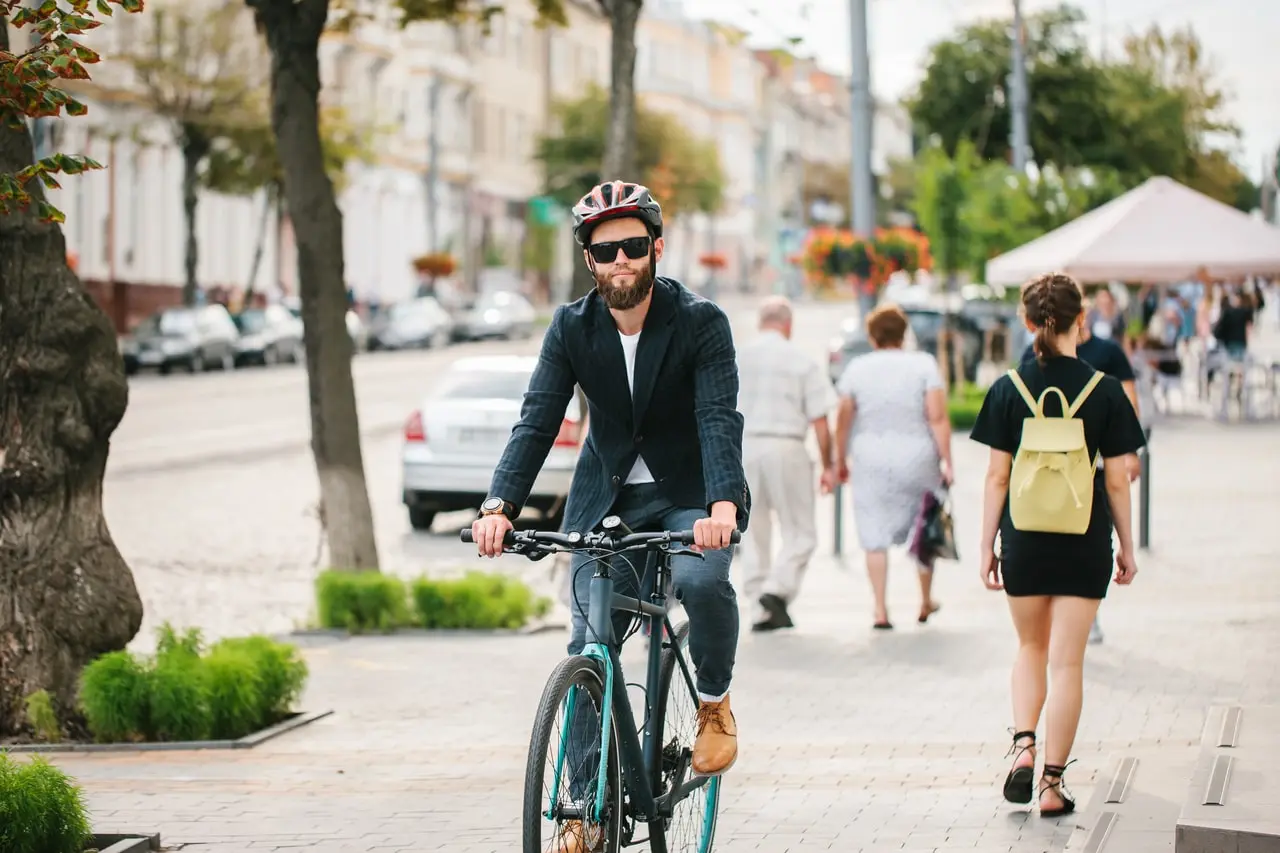 Commuter riding a bike down a city street Commuter riding a bike down a city street