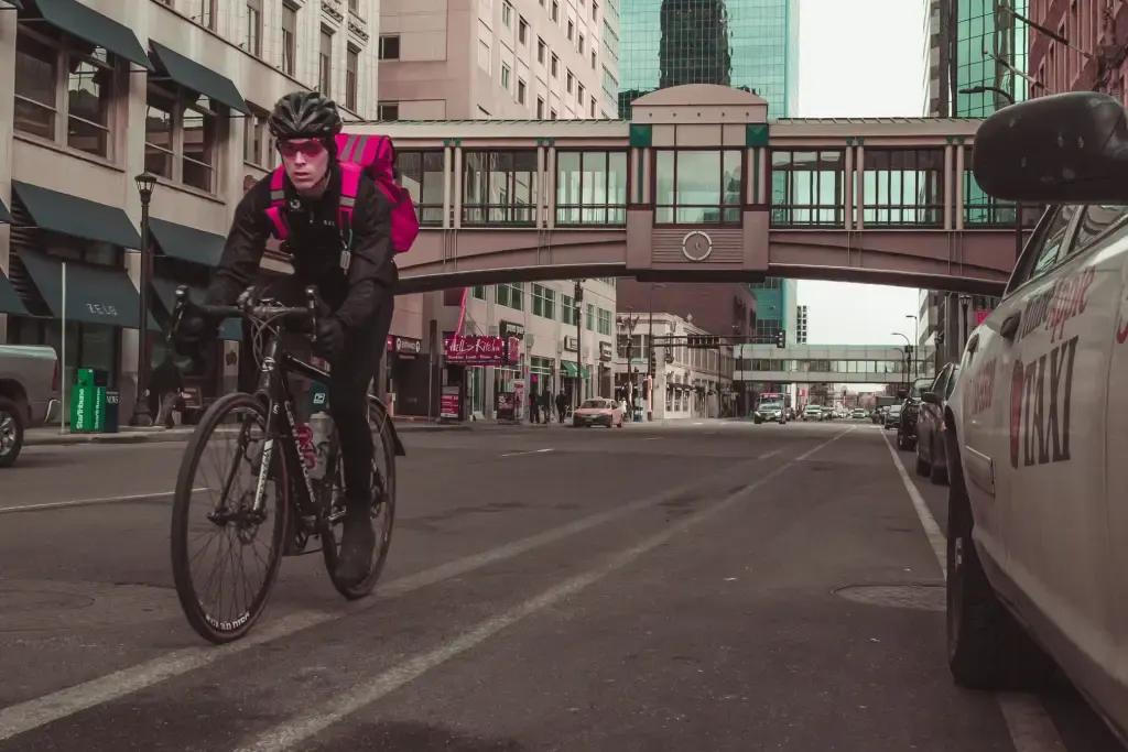Cyclist riding through downtown traffic