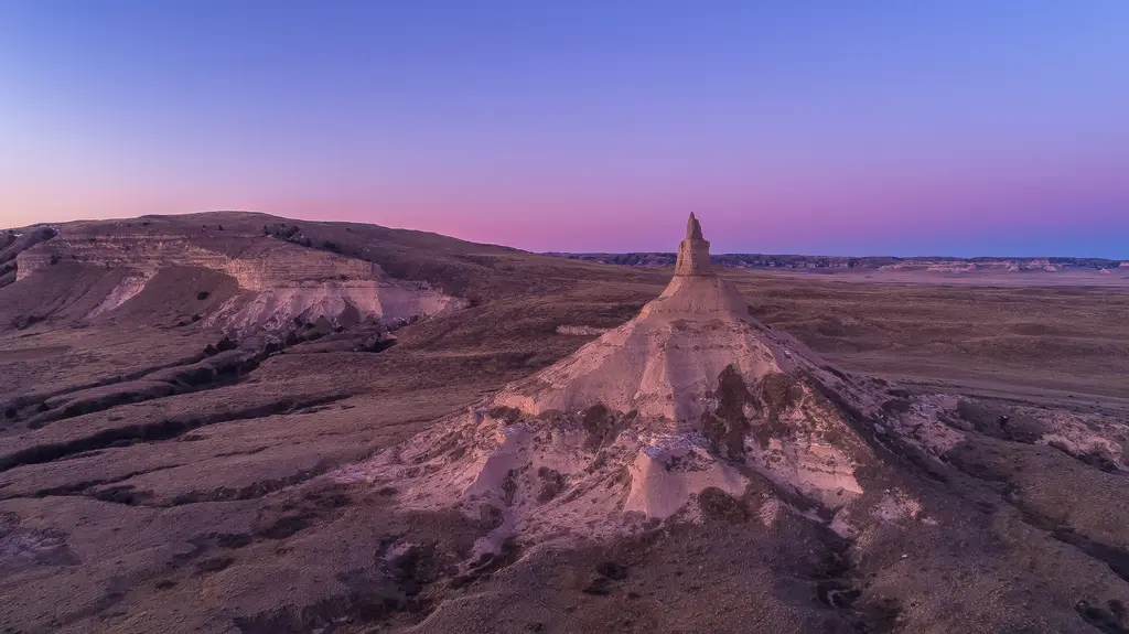 Chimney Rock rising over the western Nebraska plains at dusk