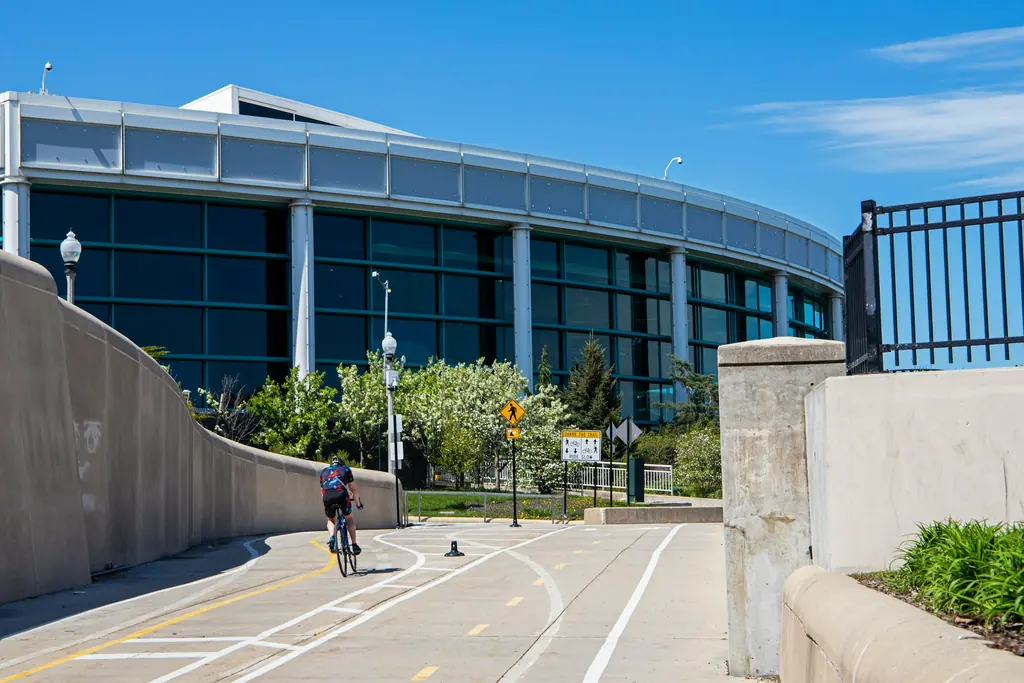 Cyclist riding a paved greenway trail in Ohio